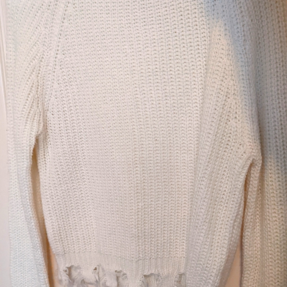 Frayed white knitted sweater